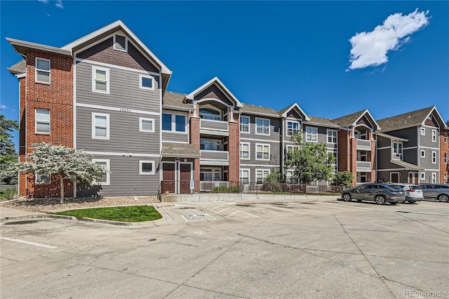 14251 E 1st Dr Unit 305, Aurora, CO 80011 - view of building exterior featuring uncovered parking and a residential view