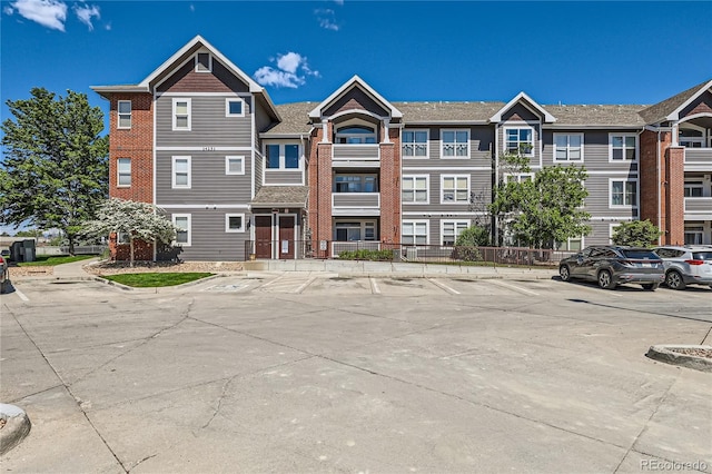 14251 E 1st Dr Unit 305, Aurora, CO 80011 - view of property featuring uncovered parking