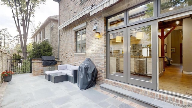 view of patio with outdoor lounge area and area for grilling