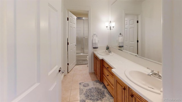 bathroom with tile patterned flooring, vanity, and shower / bath combination with glass door