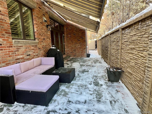 snow covered patio with an outdoor hangout area