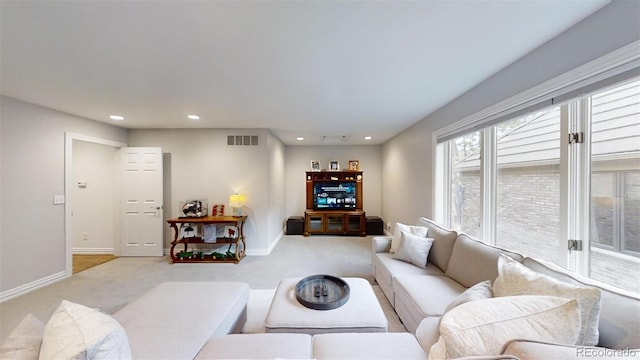 living room with recessed lighting, carpet flooring, visible vents, and baseboards