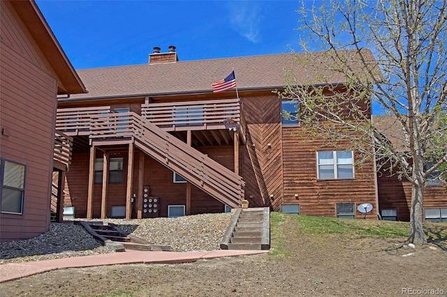 2242 Stepping Stones Way, Colorado Springs, CO 80904 - back of house featuring stairway, a chimney, a shingled roof, and a deck