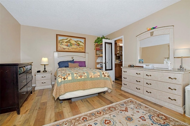 2242 Stepping Stones Way, Colorado Springs, CO 80904 - bedroom featuring light wood finished floors and a textured ceiling