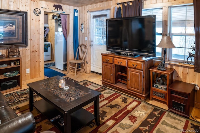 living room featuring light wood-style floors and wooden walls