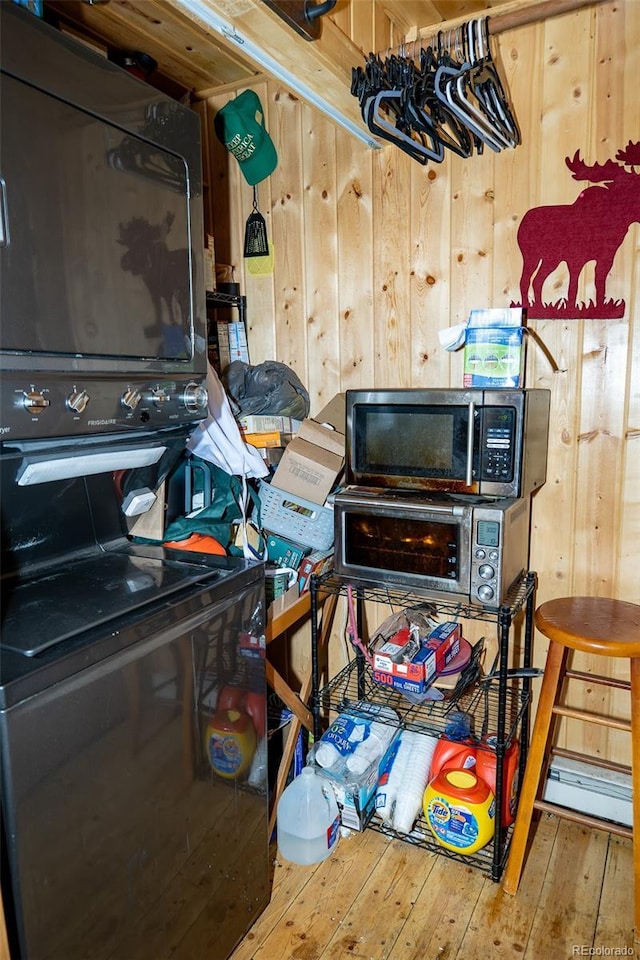 miscellaneous room with wooden walls and hardwood / wood-style flooring