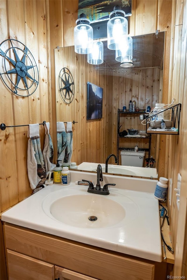 bathroom featuring wood walls and vanity