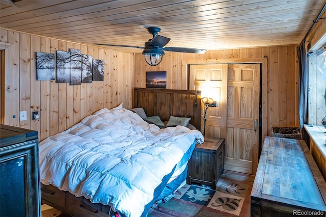 bedroom featuring a closet, wooden ceiling, and wood walls