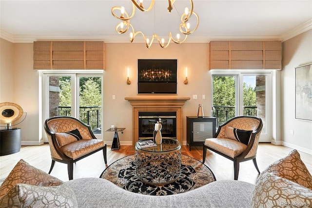 2400 E Cherry Creek S Drive 307, Denver, CO 80209 - living room featuring a chandelier, ornamental molding, healthy amount of natural light, a glass covered fireplace, and light wood-style floors