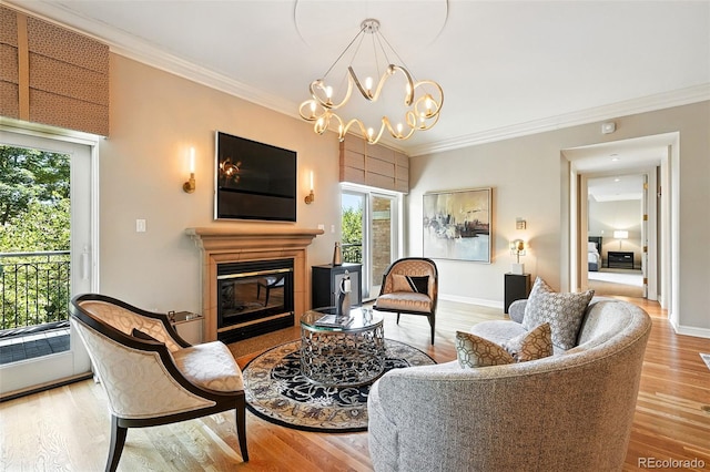 2400 E Cherry Creek S Drive 307, Denver, CO 80209 - living room featuring crown molding, wood finished floors, a glass covered fireplace, and a chandelier