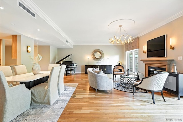 2400 E Cherry Creek S Drive 307, Denver, CO 80209 - living room with a glass covered fireplace, light wood-style floors, ornamental molding, a chandelier, and recessed lighting