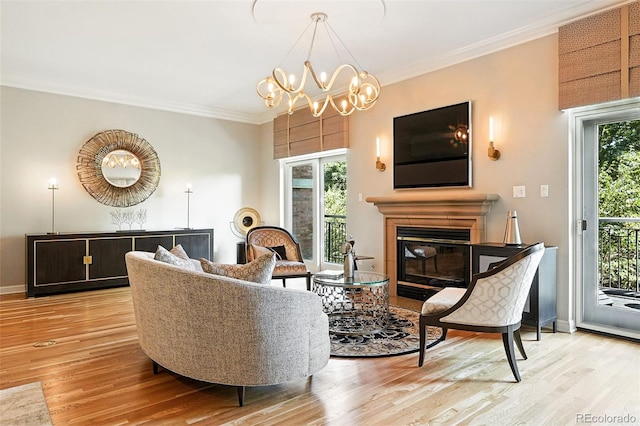 2400 E Cherry Creek S Drive 307, Denver, CO 80209 - living room featuring light wood finished floors, a glass covered fireplace, ornamental molding, and a chandelier