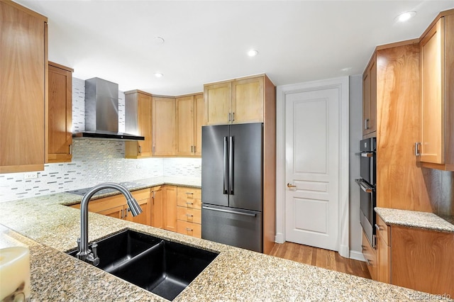 2400 E Cherry Creek S Drive 307, Denver, CO 80209 - kitchen featuring stainless steel appliances, wall chimney range hood, light wood finished floors, light stone counters, and recessed lighting