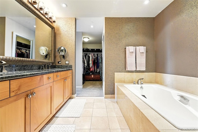 2400 E Cherry Creek S Drive 307, Denver, CO 80209 - bathroom with vanity, a garden tub, a spacious closet, tile patterned floors, and recessed lighting