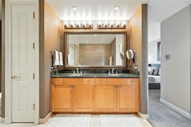 2400 E Cherry Creek S Drive 307, Denver, CO 80209 - ensuite bathroom featuring double vanity and baseboards