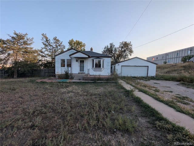 view of front facade featuring an outbuilding and a garage