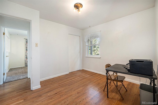 office space with baseboards and wood finished floors