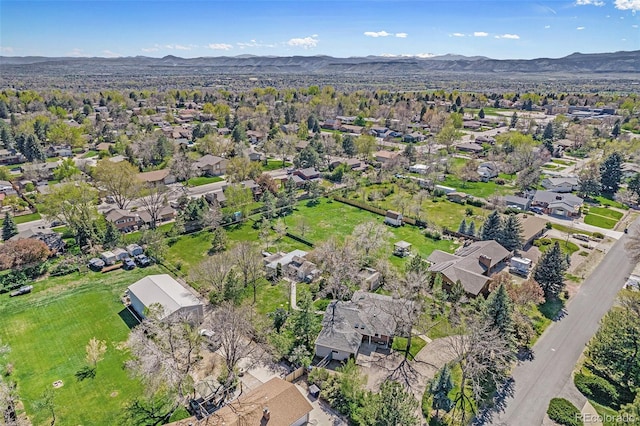 aerial overview of property's location featuring nearby suburban area and a mountain backdrop