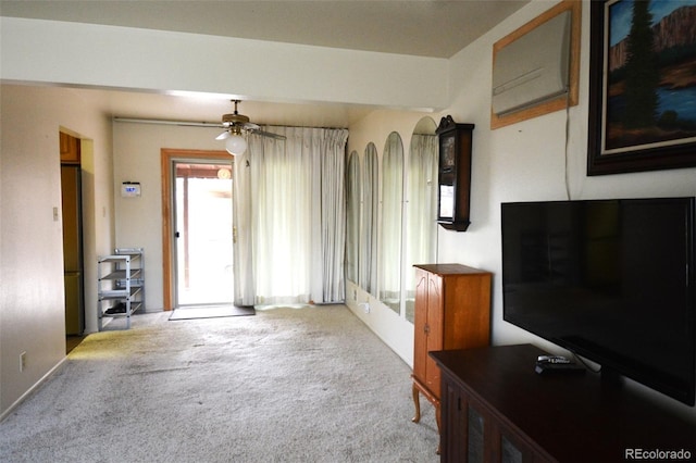 unfurnished living room featuring carpet and a ceiling fan