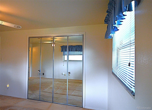 unfurnished bedroom featuring multiple windows and a closet