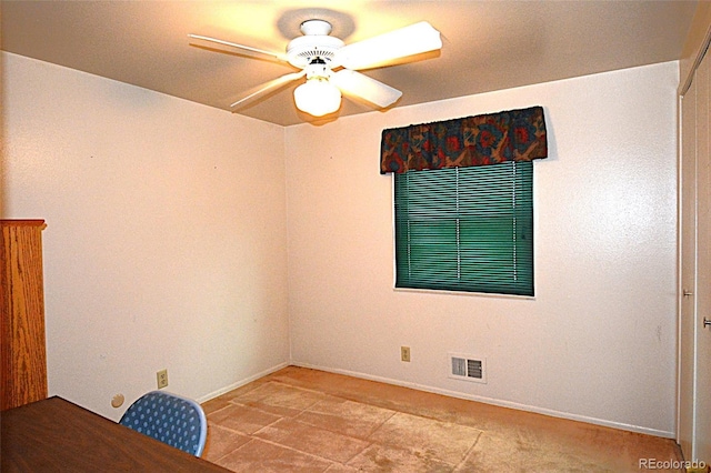 tiled spare room with a ceiling fan, baseboards, and visible vents