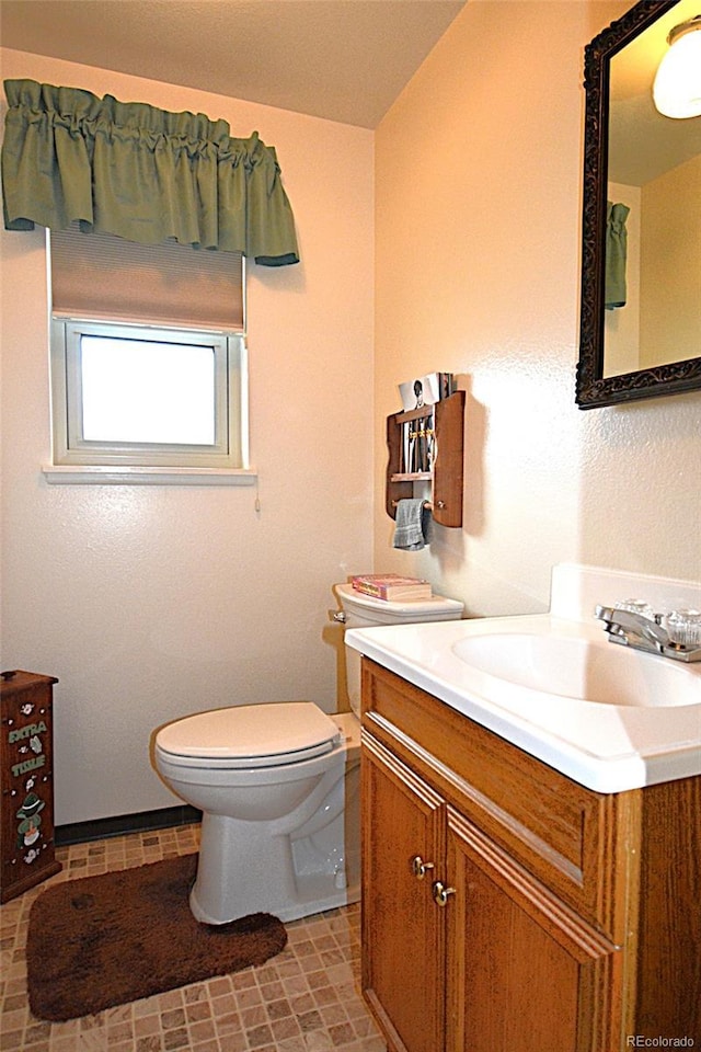 bathroom with toilet and vanity