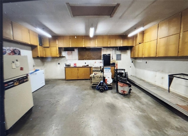 interior space featuring freestanding refrigerator and a workshop area