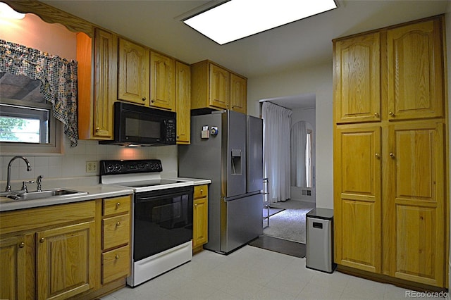 11823 Williams Way, Northglenn, CO 80233 - kitchen with electric range oven, stainless steel fridge with ice dispenser, black microwave, a sink, and light countertops