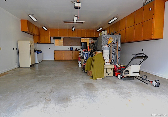 11823 Williams Way, Northglenn, CO 80233 - garage featuring freestanding refrigerator, a garage door opener, and baseboards