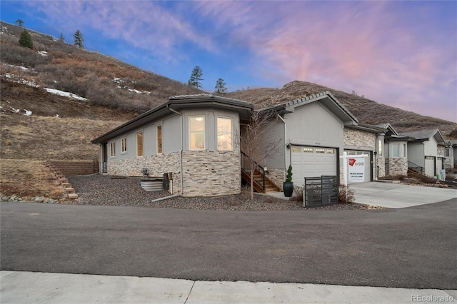 view of front facade featuring a mountain view and a garage