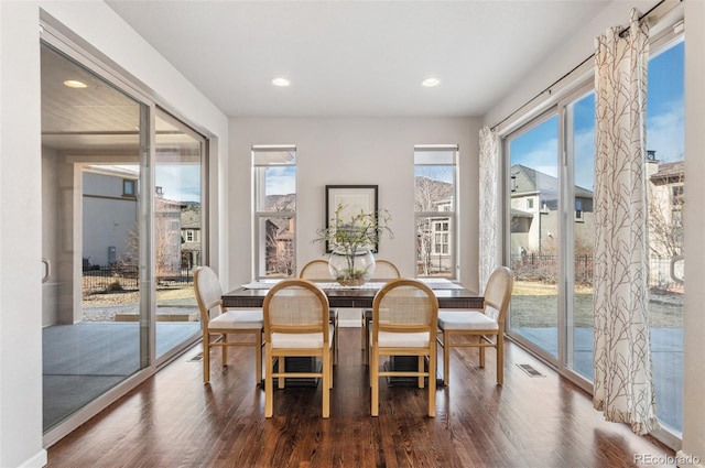 dining space featuring visible vents, recessed lighting, and wood finished floors