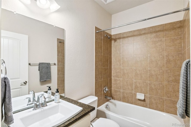 bathroom featuring tub / shower combination, toilet, and vanity