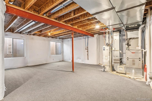 below grade area featuring heating unit, gas water heater, and carpet floors