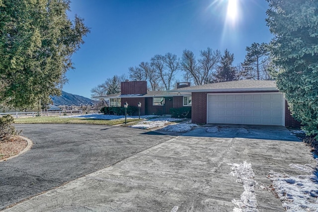 ranch-style house featuring a mountain view and a garage