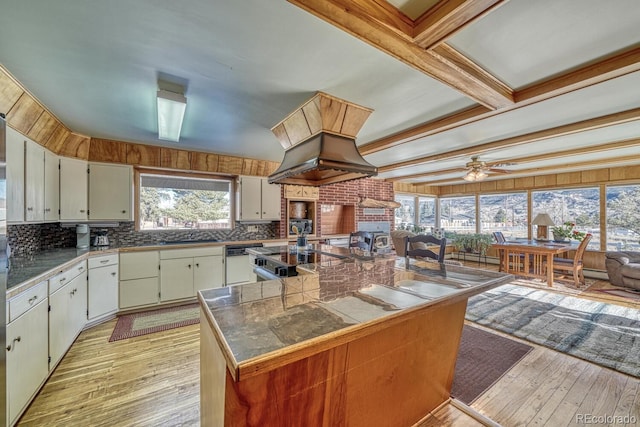 kitchen featuring ceiling fan, tasteful backsplash, light hardwood / wood-style flooring, beamed ceiling, and white dishwasher