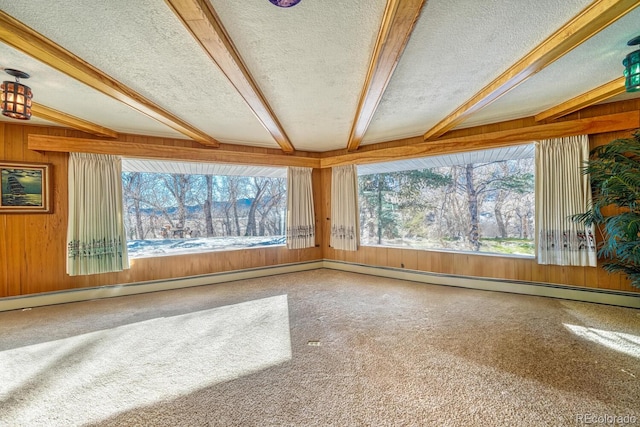 unfurnished sunroom featuring vaulted ceiling with beams, plenty of natural light, and a baseboard heating unit