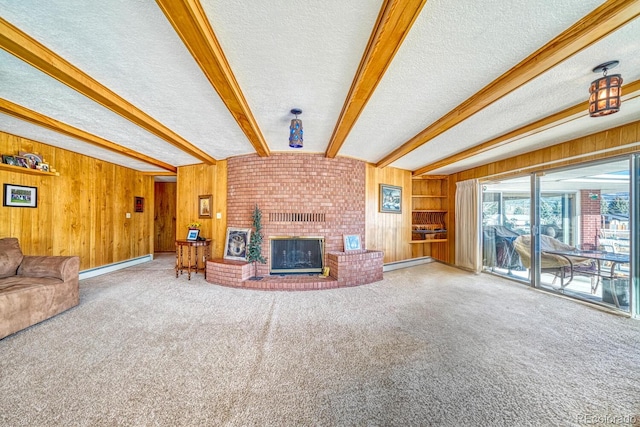 living room featuring a brick fireplace, a textured ceiling, beam ceiling, carpet floors, and wood walls