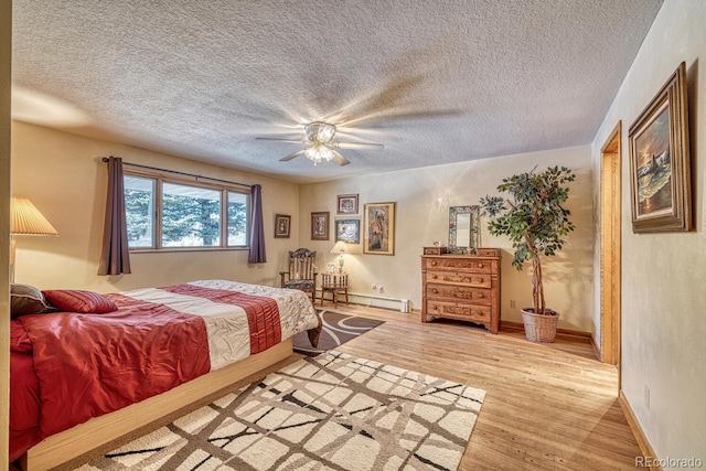 bedroom with wood-type flooring, a textured ceiling, ceiling fan, and a baseboard heating unit