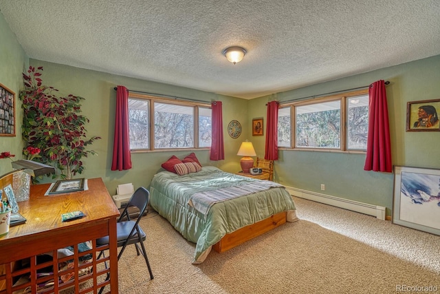 carpeted bedroom with a textured ceiling and a baseboard heating unit