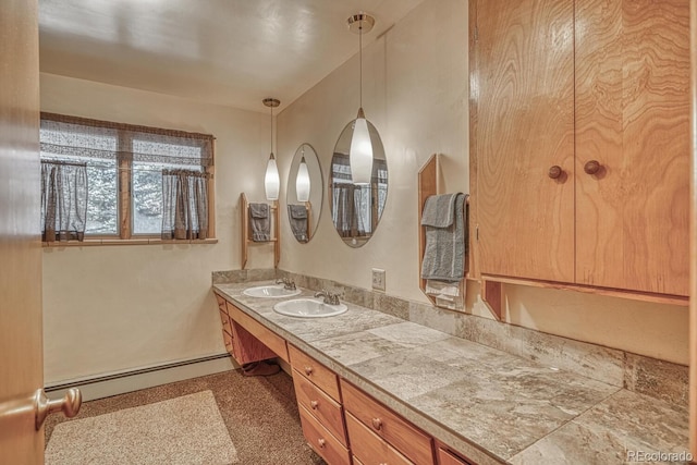 bathroom with vanity and baseboard heating