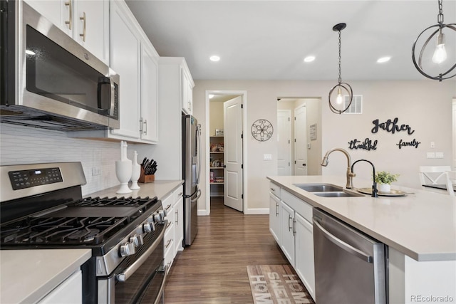 16400 Alberta Dr, Parker, CO 80134 - kitchen with appliances with stainless steel finishes, a sink, white cabinets, decorative backsplash, and dark wood-style flooring