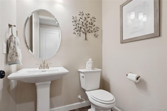 16400 Alberta Dr, Parker, CO 80134 - bathroom featuring toilet, baseboards, and wood finished floors