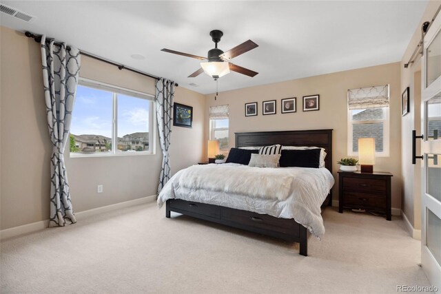 16400 Alberta Dr, Parker, CO 80134 - bedroom with light carpet, baseboards, a barn door, and a ceiling fan