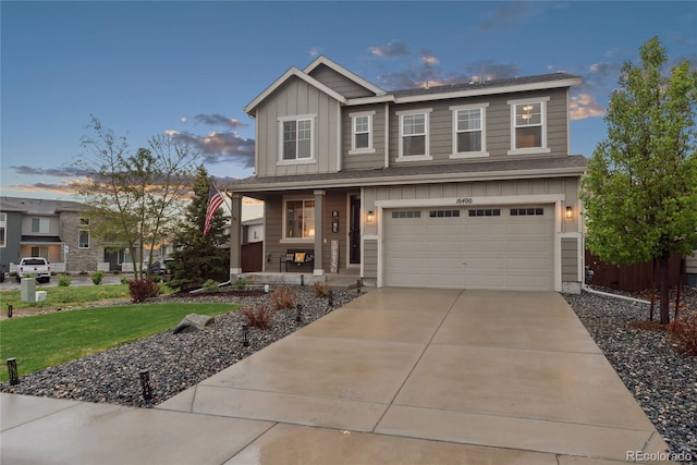 16400 Alberta Dr, Parker, CO 80134 - view of front facade featuring a porch, board and batten siding, a garage, concrete driveway, and a yard