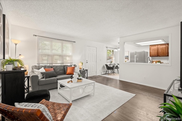 670 Winona Ct Unit 38, Denver, CO 80204 - living area with wood finished floors, a textured ceiling, and baseboards