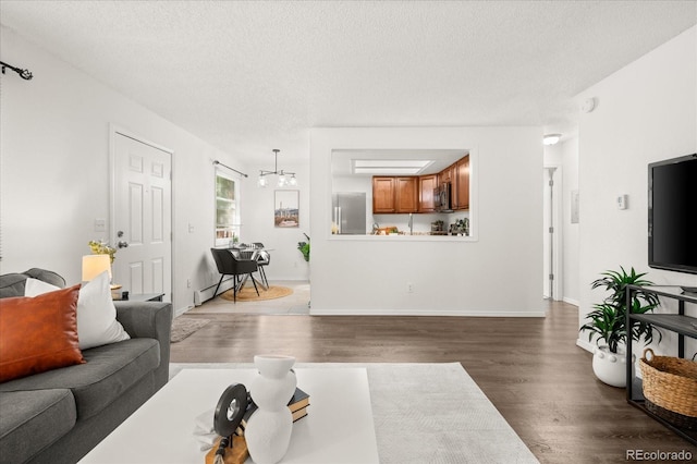 670 Winona Ct Unit 38, Denver, CO 80204 - living room featuring wood finished floors, a textured ceiling, and baseboards