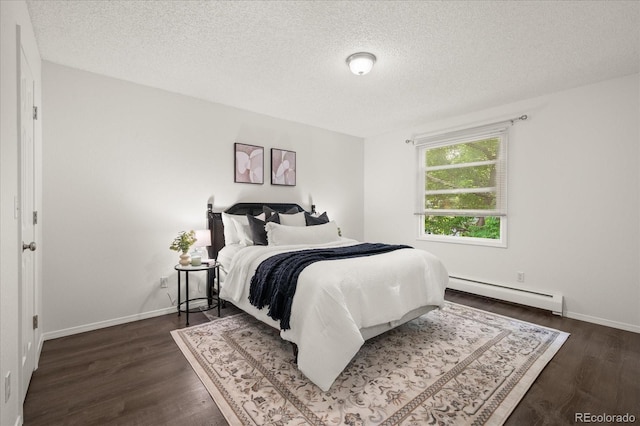 670 Winona Ct Unit 38, Denver, CO 80204 - bedroom featuring baseboard heating, a textured ceiling, dark wood-type flooring, and baseboards