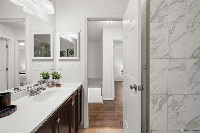 670 Winona Ct Unit 38, Denver, CO 80204 - bathroom featuring vanity and wood finished floors