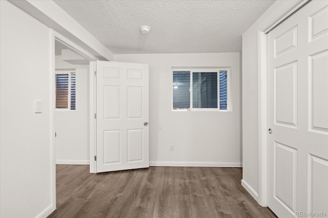 670 Winona Ct Unit 38, Denver, CO 80204 - empty room with wood finished floors, baseboards, a textured ceiling, and a smoke detector