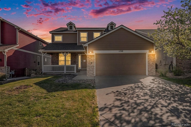 11748 Mill Valley St, Parker, CO 80138 - view of front facade with a porch, a garage, stone siding, and driveway